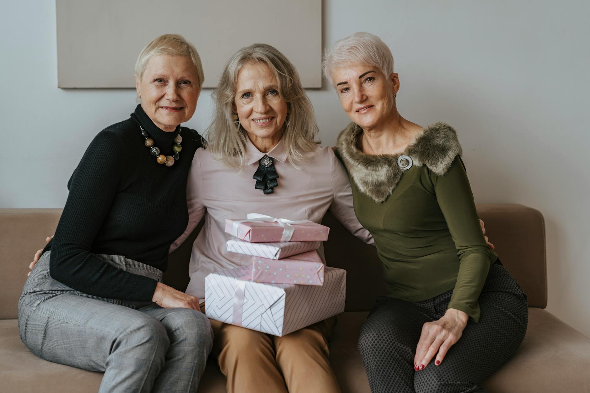 group of women sitting together on a couch