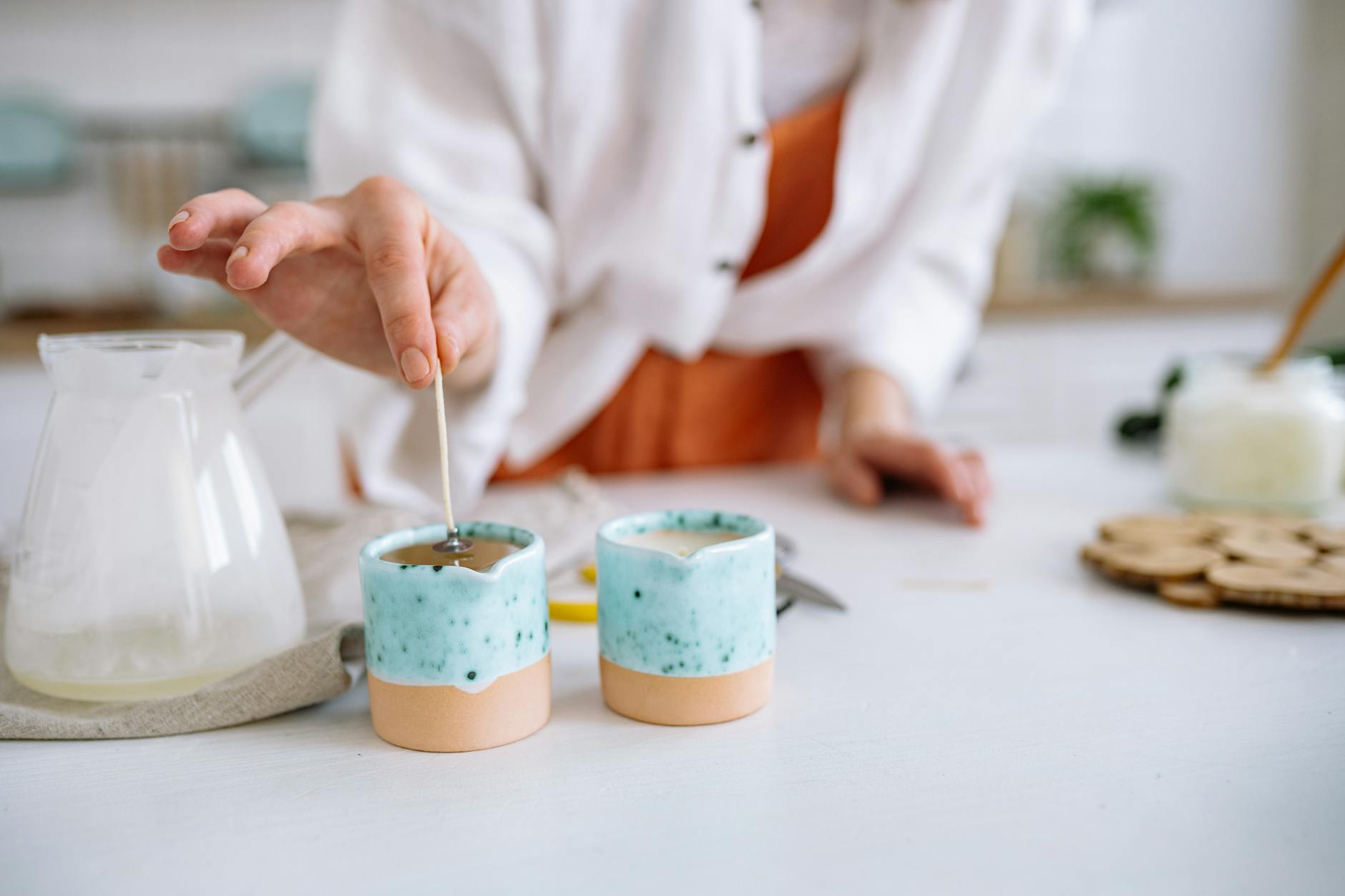 person making handmade candle
