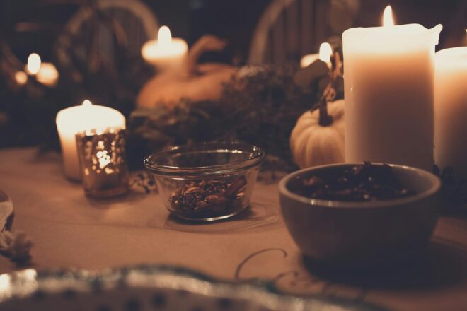 pillar candles beside bowls on table