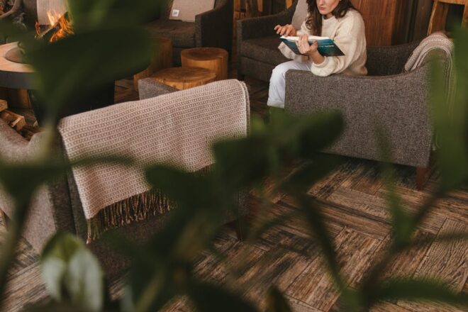 woman sitting on a sofa chair reading a book