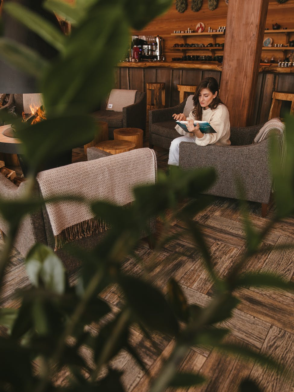 woman sitting on a sofa chair reading a book
