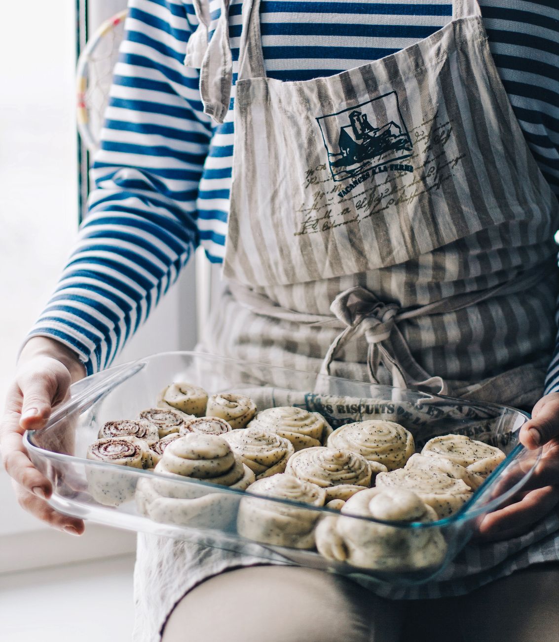 person holding tray of breads