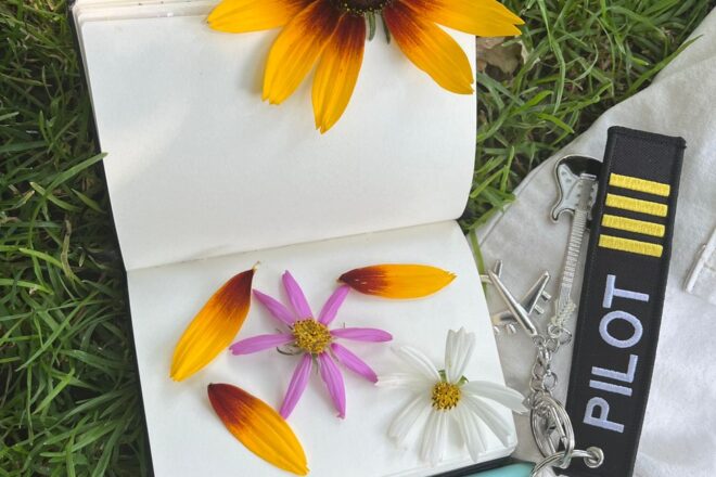 colorful journal with flowers on grass