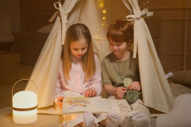 children reading a book inside a room