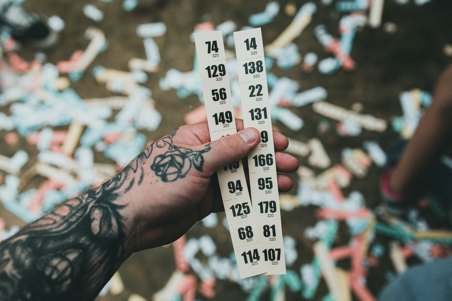 a person holding a ticket with numbers on it