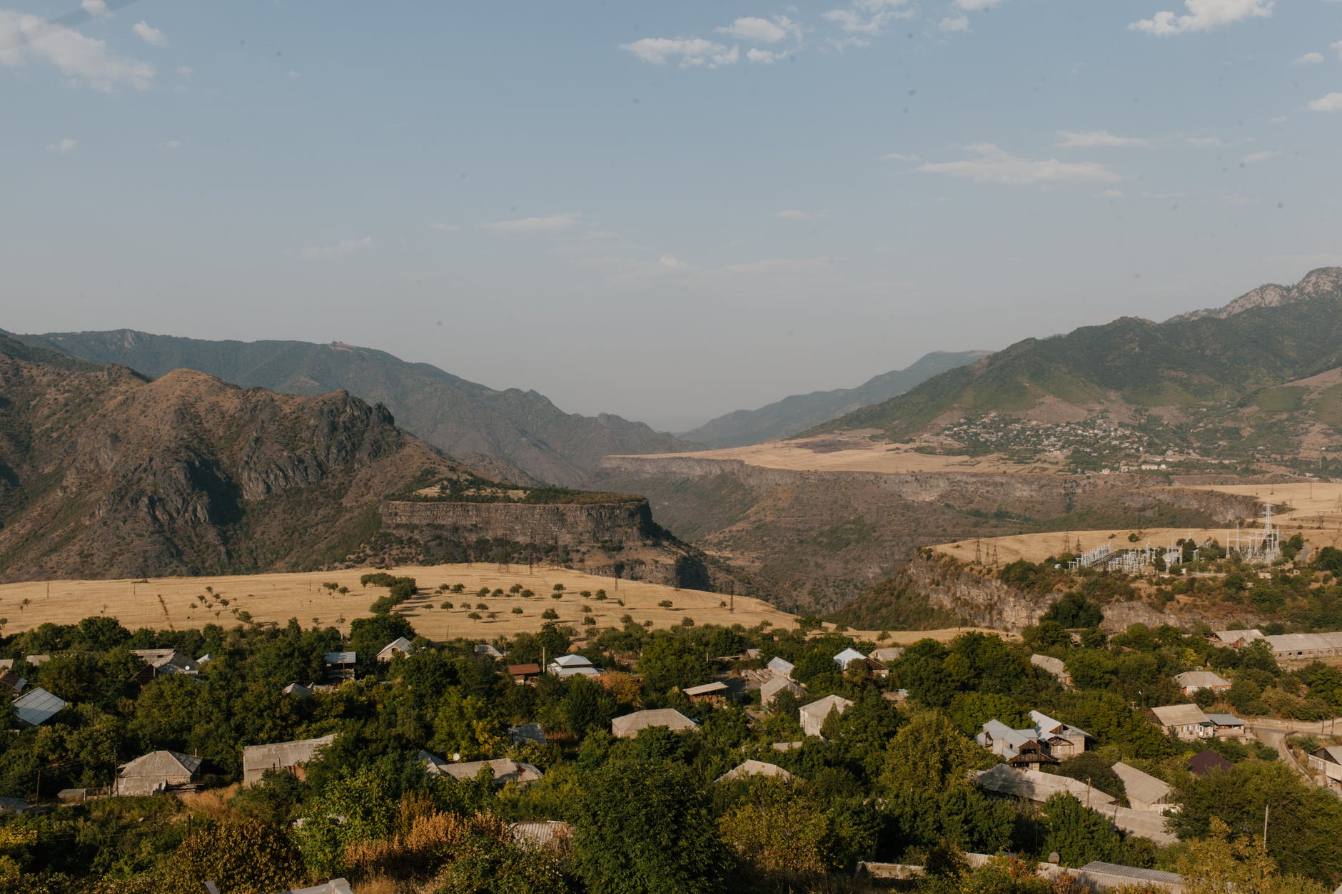 small settlement located in green valley in mountainous terrain