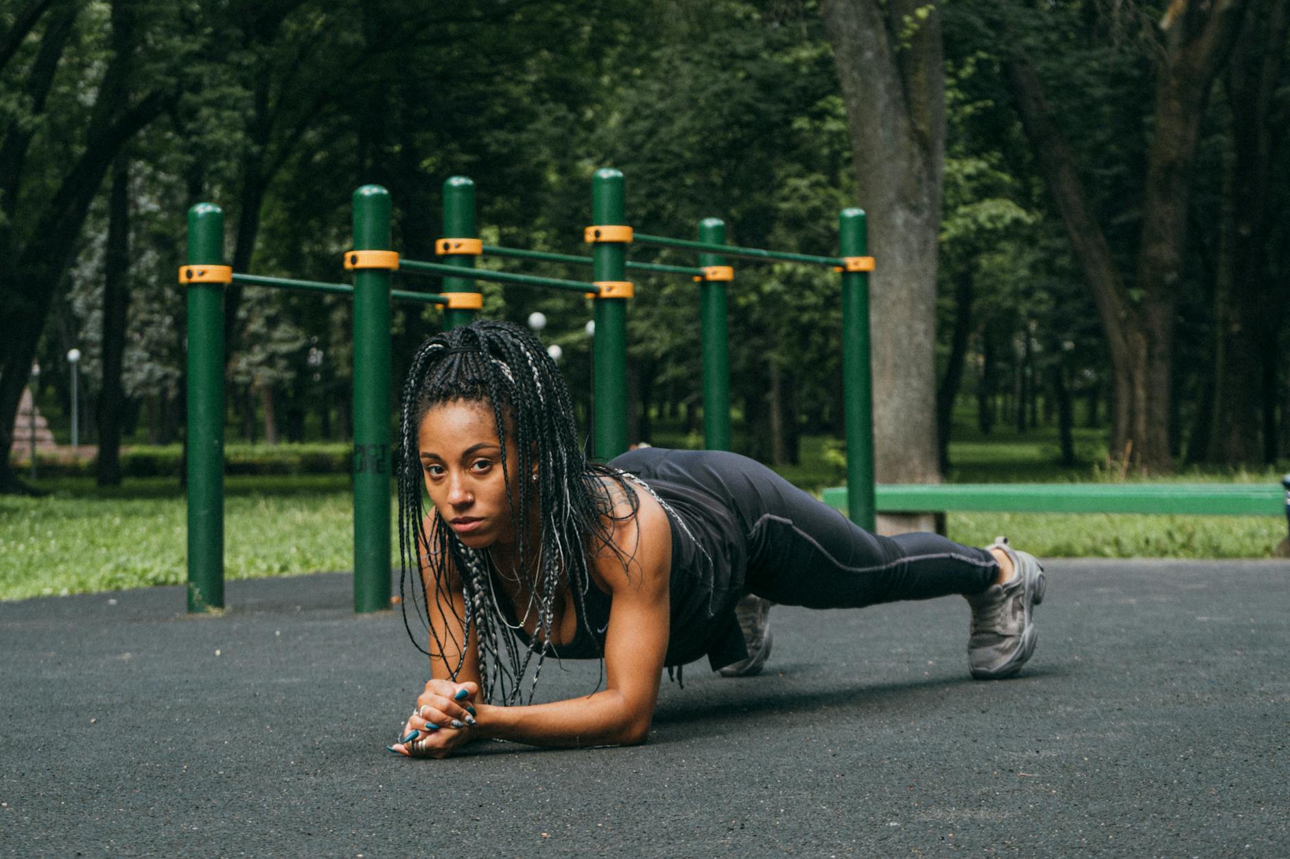 a woman exercising on the park playground