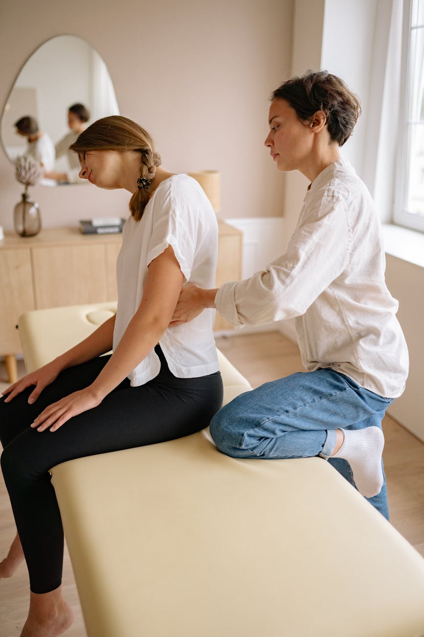 a therapist massaging the woman s back