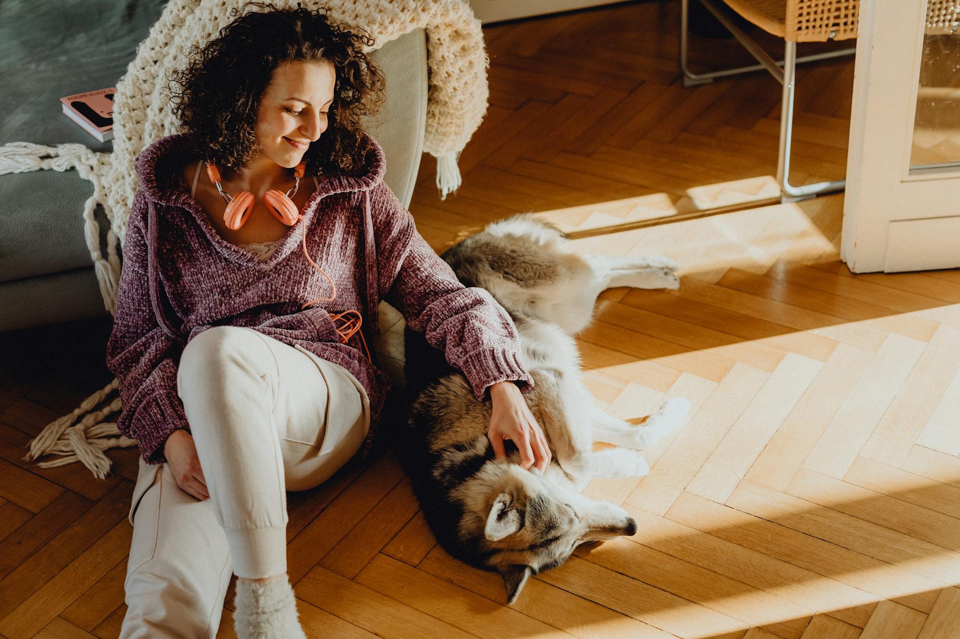 woman with a dog sitting on the floor