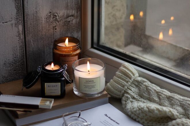 a lighted candles by the window
