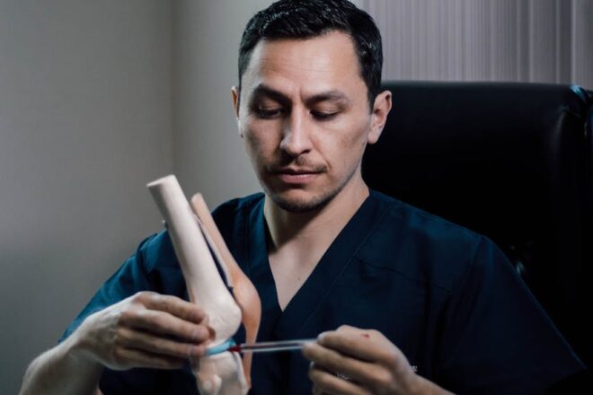 doctor demonstrating knee joint anatomy in office
