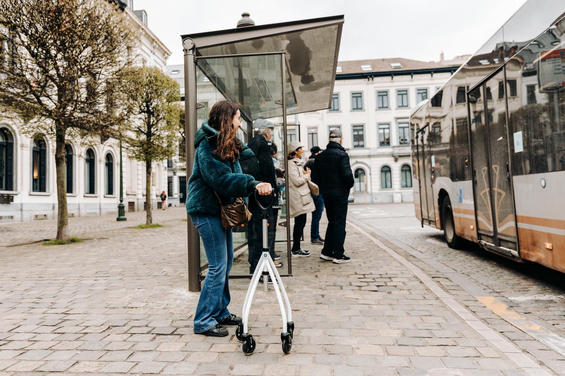 urban bus stop with people and rollator walker